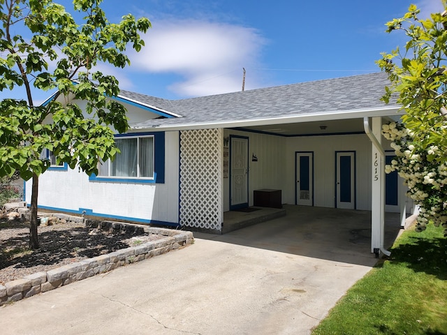 1615 Ballard Ln, Winnemucca, NV 89445 - view of front of home with roof with shingles, a carport, and concrete driveway