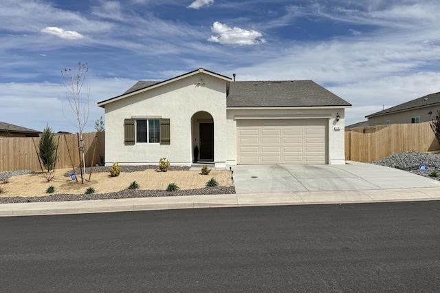 1733 Treeline Dr, Fernley, NV 89408 - view of front of home with an attached garage, stucco siding, concrete driveway, and a shingled roof