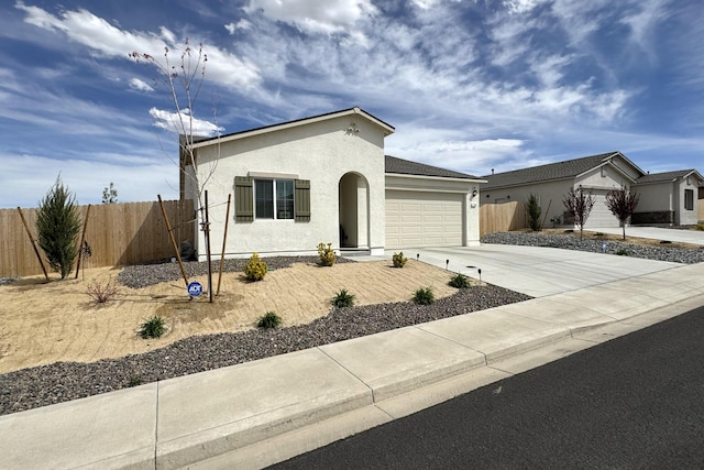 1733 Treeline Dr, Fernley, NV 89408 - view of front of home with an attached garage, concrete driveway, and stucco siding
