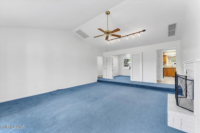 3277 Dartmouth Ct, Carson City, NV 89703 - unfurnished living room with a ceiling fan, lofted ceiling, light carpet, a fireplace, and baseboards