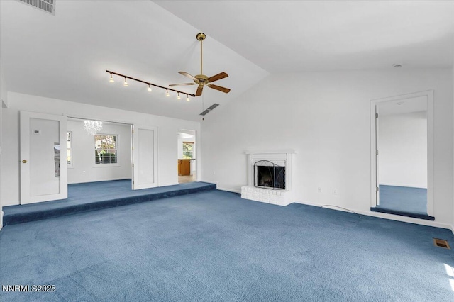 3277 Dartmouth Ct, Carson City, NV 89703 - unfurnished living room with ceiling fan, carpet, a brick fireplace, track lighting, and a chandelier