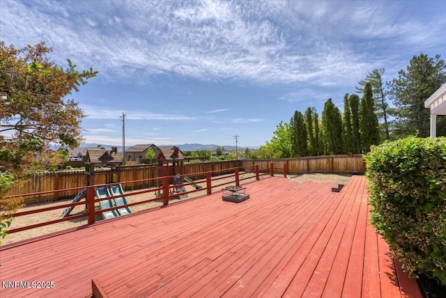 3277 Dartmouth Ct, Carson City, NV 89703 - deck with a fenced backyard, a playground, and a mountain view