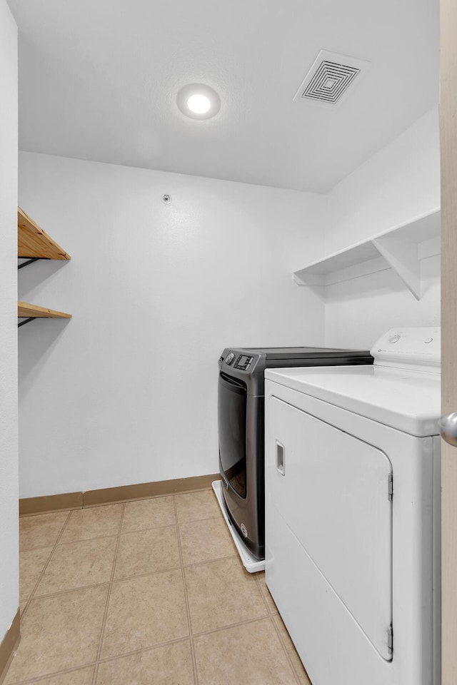 6850 Sharlands Ave Unit H2044, Reno, NV 89523 - laundry room featuring washing machine and dryer, baseboards, and light tile patterned floors