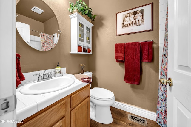 1635 Black Oak Rd, Sparks, NV 89436 - bathroom featuring vanity, toilet, wood finished floors, baseboards, and a shower with curtain