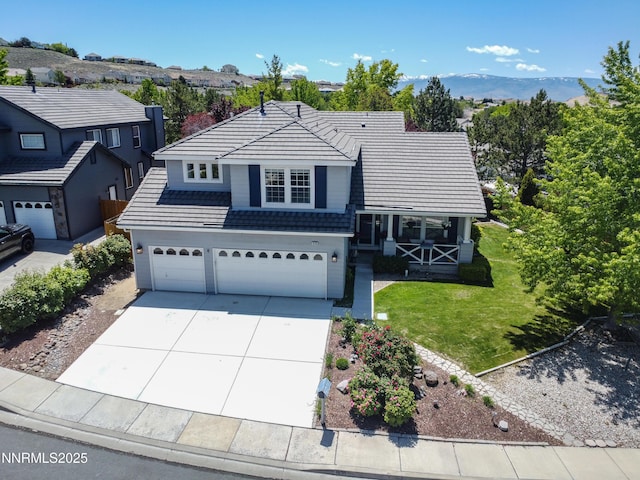1635 Black Oak Rd, Sparks, NV 89436 - view of front of house with an attached garage, concrete driveway, a tile roof, covered porch, and a front yard