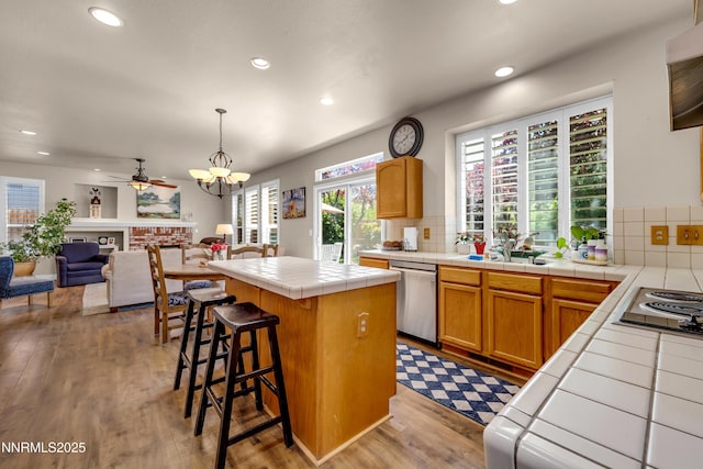 1635 Black Oak Rd, Sparks, NV 89436 - kitchen with tile counters, appliances with stainless steel finishes, decorative backsplash, recessed lighting, and wood finished floors
