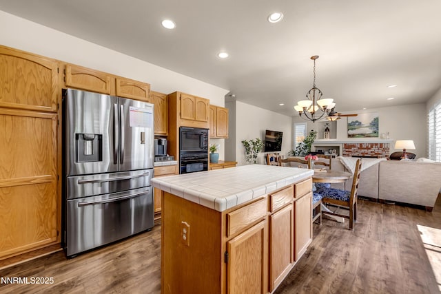 1635 Black Oak Rd, Sparks, NV 89436 - kitchen featuring stainless steel fridge with ice dispenser, tile countertops, a chandelier, open floor plan, and recessed lighting