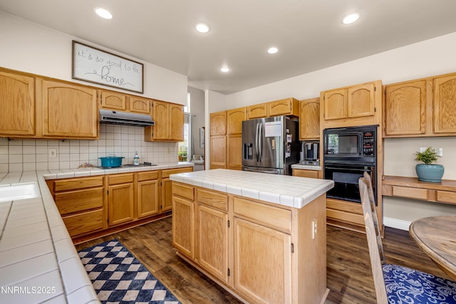 1635 Black Oak Rd, Sparks, NV 89436 - kitchen featuring black appliances, under cabinet range hood, tile counters, dark wood finished floors, and decorative backsplash