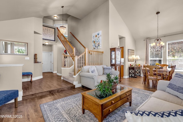 1635 Black Oak Rd, Sparks, NV 89436 - living area featuring a chandelier, high vaulted ceiling, wood finished floors, stairway, and baseboards