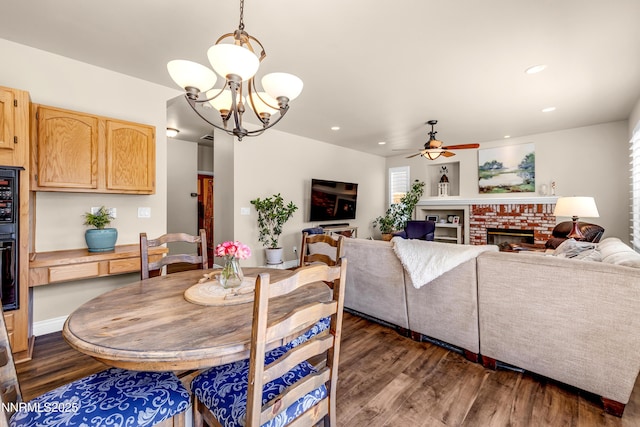 1635 Black Oak Rd, Sparks, NV 89436 - dining space featuring dark wood-style flooring, a ceiling fan, recessed lighting, a brick fireplace, and a chandelier