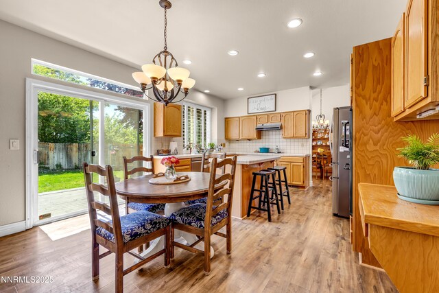 1635 Black Oak Rd, Sparks, NV 89436 - dining room with a chandelier, light wood finished floors, plenty of natural light, and recessed lighting