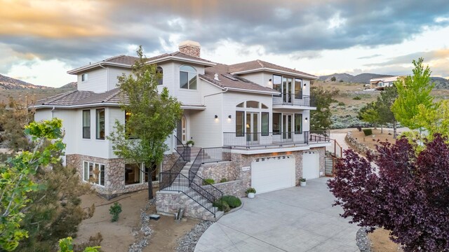 17144 Majestic View Dr, Reno, NV 89521 - view of front of home with a balcony, stairs, a chimney, a garage, and driveway