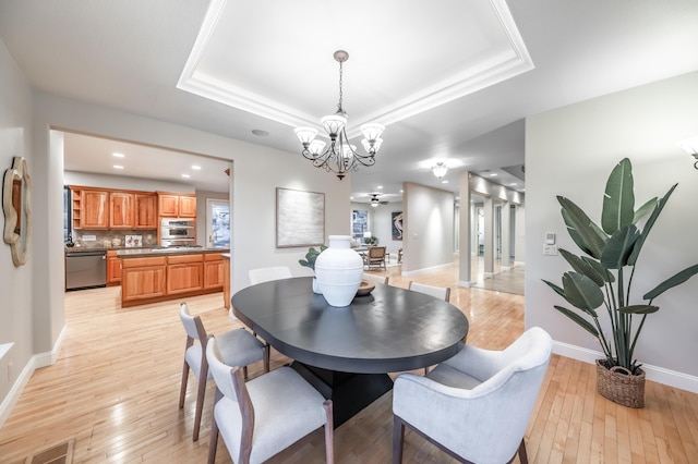 17144 Majestic View Dr, Reno, NV 89521 - dining area featuring light wood-style floors, a chandelier, baseboards, a tray ceiling, and recessed lighting