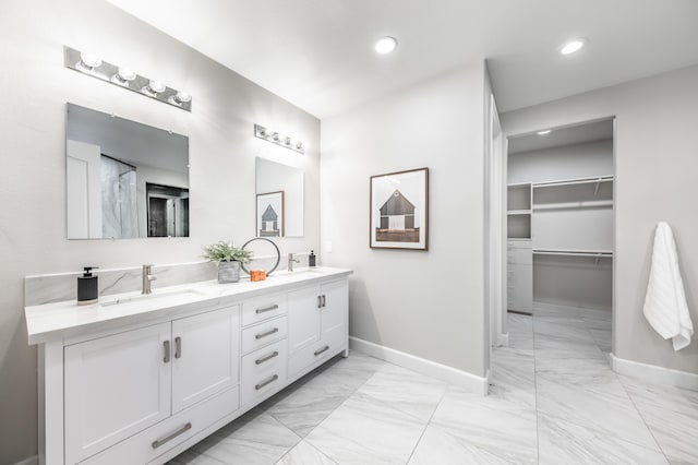 17144 Majestic View Dr, Reno, NV 89521 - bathroom featuring marble finish flooring, baseboards, recessed lighting, double vanity, and a walk in closet
