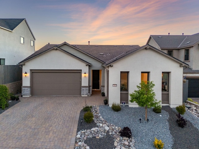 15025 Iron River Dr, Reno, NV 89521 - view of front of house with a garage, decorative driveway, and stucco siding