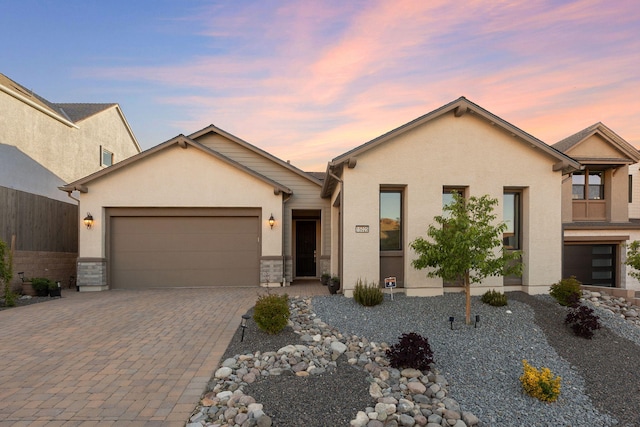 15025 Iron River Dr, Reno, NV 89521 - view of front of property with decorative driveway, an attached garage, and stucco siding
