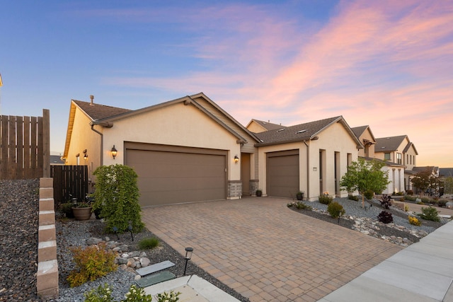 15025 Iron River Dr, Reno, NV 89521 - view of front of home featuring a garage, stucco siding, and decorative driveway