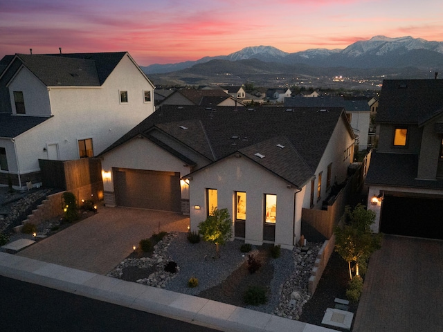 15025 Iron River Dr, Reno, NV 89521 - view of front of property with a mountain view, driveway, a garage, and stucco siding