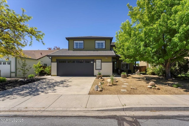 5540 Twin Creeks Dr, Reno, NV 89523 - traditional-style house featuring a tiled roof, concrete driveway, a garage, and brick siding
