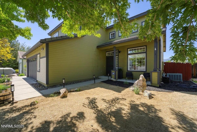 5540 Twin Creeks Dr, Reno, NV 89523 - view of front of home with covered porch, cooling unit, and an attached garage