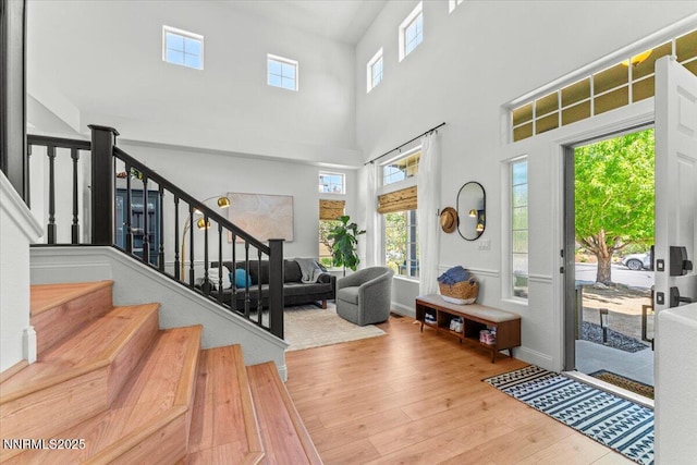 5540 Twin Creeks Dr, Reno, NV 89523 - foyer entrance featuring wood finished floors, plenty of natural light, stairs, and a high ceiling