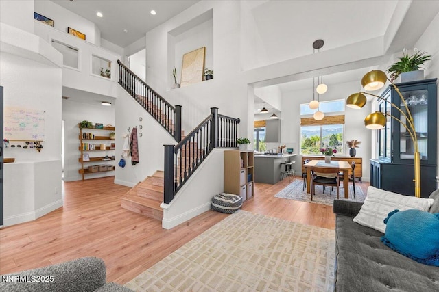 5540 Twin Creeks Dr, Reno, NV 89523 - living area with light wood-style flooring, stairs, a towering ceiling, baseboards, and recessed lighting
