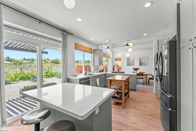5540 Twin Creeks Dr, Reno, NV 89523 - kitchen featuring a sink, freestanding refrigerator, light countertops, stainless steel dishwasher, and recessed lighting