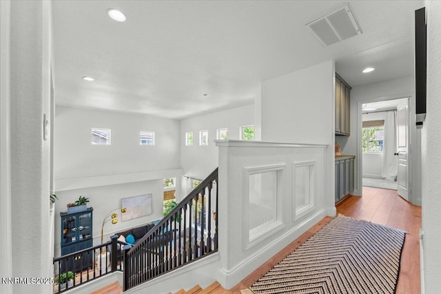 5540 Twin Creeks Dr, Reno, NV 89523 - corridor with wood finished floors, an upstairs landing, and recessed lighting