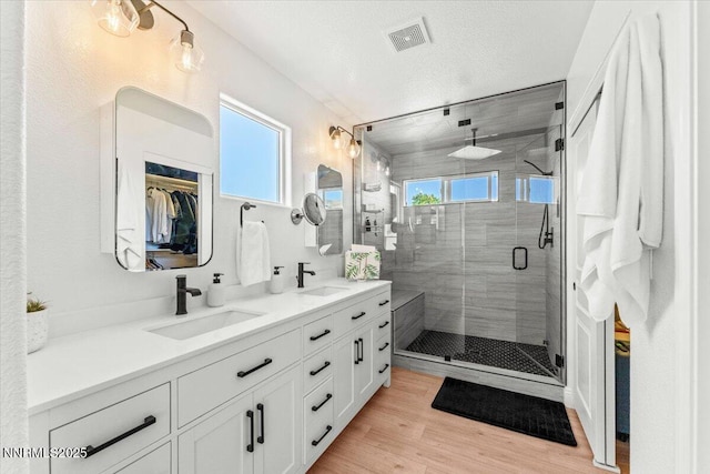 5540 Twin Creeks Dr, Reno, NV 89523 - full bath with double vanity, a stall shower, wood finished floors, and a walk in closet
