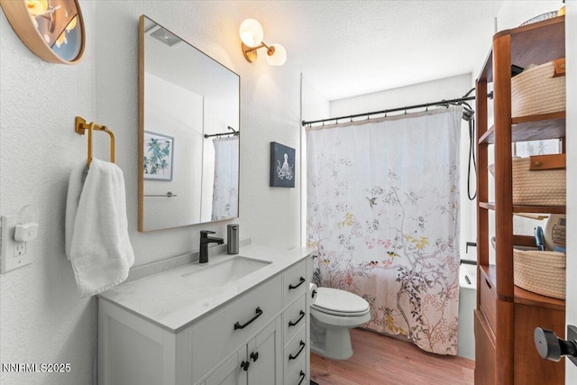 5540 Twin Creeks Dr, Reno, NV 89523 - bathroom featuring wood finished floors, vanity, toilet, shower / bathtub combination with curtain, and a textured wall
