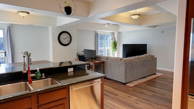 200 W 2nd St Apt 707, Reno, NV 89501 - kitchen with stainless steel dishwasher, a sink, dark countertops, light wood-style flooring, and a ceiling fan