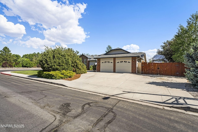 1316 Northampton Cir, Gardnerville, NV 89410 - view of front of home with an attached garage, driveway, and brick siding