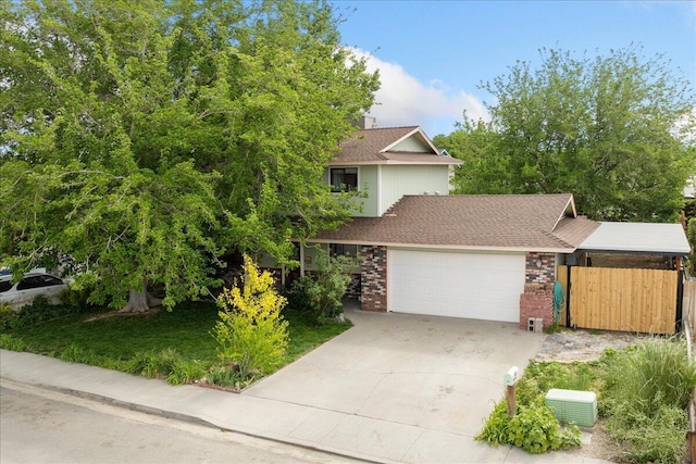 410 Pheasant Dr, Fallon, NV 89406 - view of property hidden behind natural elements with a garage, brick siding, concrete driveway, and a shingled roof