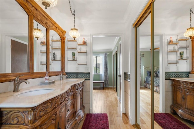 410 Pheasant Dr, Fallon, NV 89406 - full bathroom with double vanity, ornamental molding, and wood finished floors