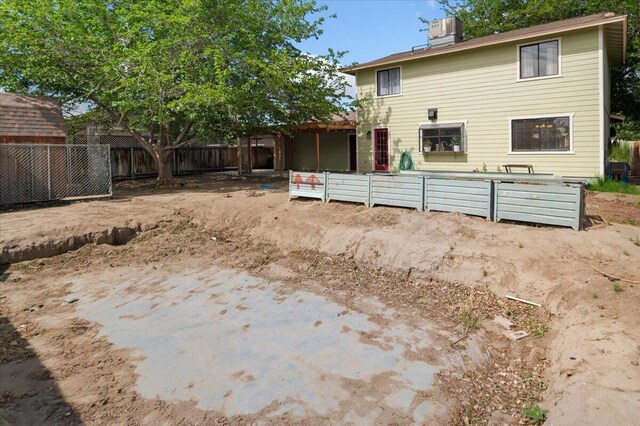 410 Pheasant Dr, Fallon, NV 89406 - rear view of house with a chimney and cooling unit