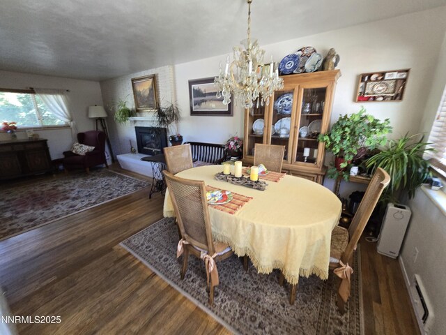 1290 Westwood Dr, Reno, NV 89509 - dining area with wood finished floors, a large fireplace, and a chandelier