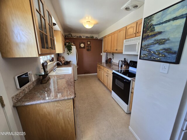 1290 Westwood Dr, Reno, NV 89509 - kitchen featuring white microwave, electric range, a sink, glass insert cabinets, and baseboards