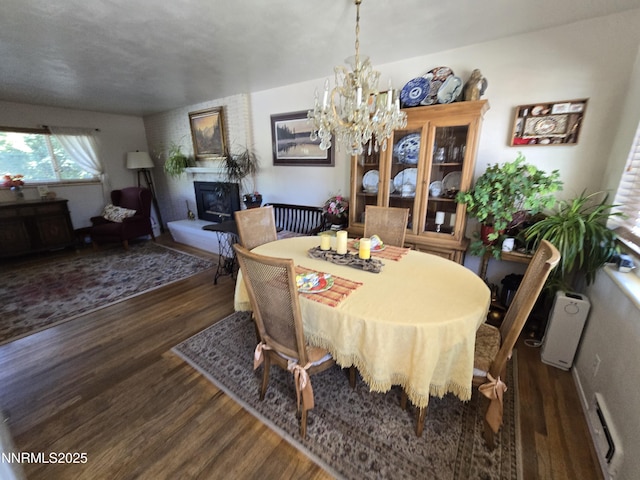1290 Westwood Dr, Reno, NV 89509 - dining area with wood finished floors, a large fireplace, and a chandelier