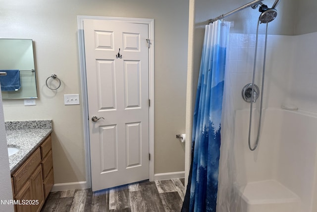 3185 Cliffrose Dr, Silver Springs, NV 89429 - full bathroom with vanity, a shower with shower curtain, wood finished floors, and baseboards
