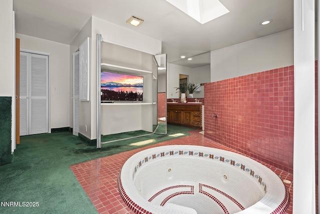 2770 Solari Dr, Reno, NV 89509 - full bath with vanity, tile walls, a tub with jets, a closet, and a skylight