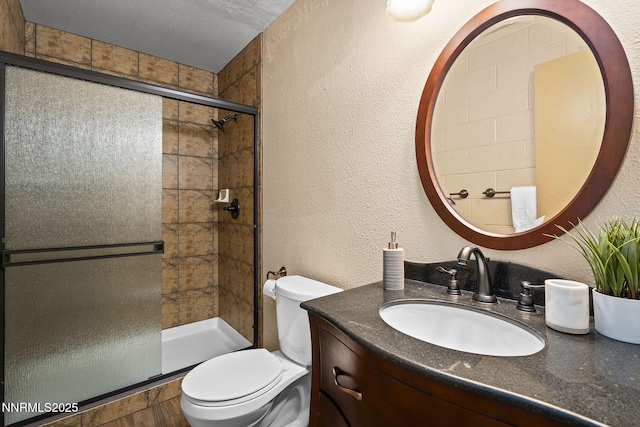 2770 Solari Dr, Reno, NV 89509 - full bathroom featuring toilet, vanity, a shower stall, and a textured wall