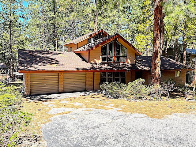 174 Hall Ct, Kingsbury, NV 89449 - chalet / cabin featuring asphalt driveway, a garage, and roof with shingles