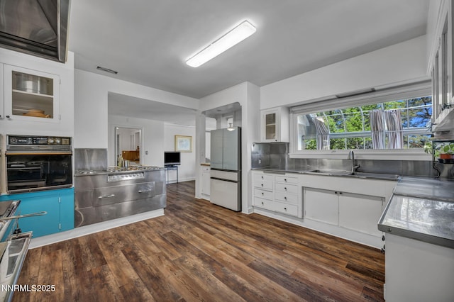 125 Greenridge Dr, Reno, NV 89509 - kitchen with stainless steel countertops, freestanding refrigerator, oven, a sink, and white cabinets