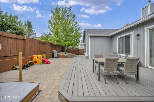 7442 Celeste Dr, Reno, NV 89511 - wooden terrace featuring a fenced backyard, outdoor dining area, and a patio