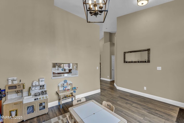 7442 Celeste Dr, Reno, NV 89511 - living area featuring a chandelier, wood finished floors, baseboards, and a high ceiling