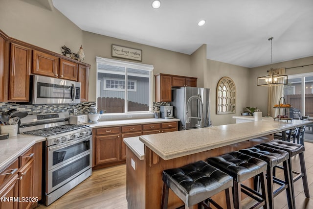 7442 Celeste Dr, Reno, NV 89511 - kitchen with stainless steel appliances, plenty of natural light, brown cabinets, and recessed lighting