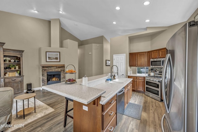 7442 Celeste Dr, Reno, NV 89511 - kitchen with appliances with stainless steel finishes, a sink, brown cabinets, open floor plan, and light countertops