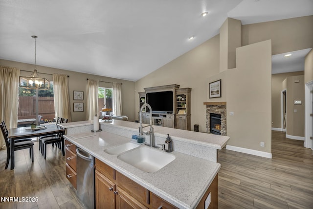 7442 Celeste Dr, Reno, NV 89511 - kitchen featuring a sink, open floor plan, brown cabinetry, a chandelier, and a kitchen island with sink