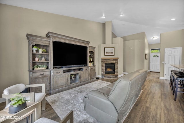 7442 Celeste Dr, Reno, NV 89511 - living area featuring hardwood / wood-style flooring, vaulted ceiling, a fireplace, baseboards, and recessed lighting