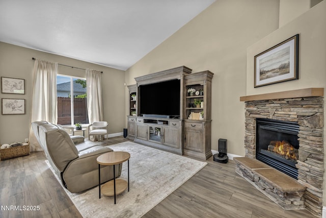 7442 Celeste Dr, Reno, NV 89511 - living area with a fireplace, wood finished floors, baseboards, and high vaulted ceiling